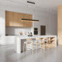 Stylish home kitchen interior with bar counter and shelves with kitchenware